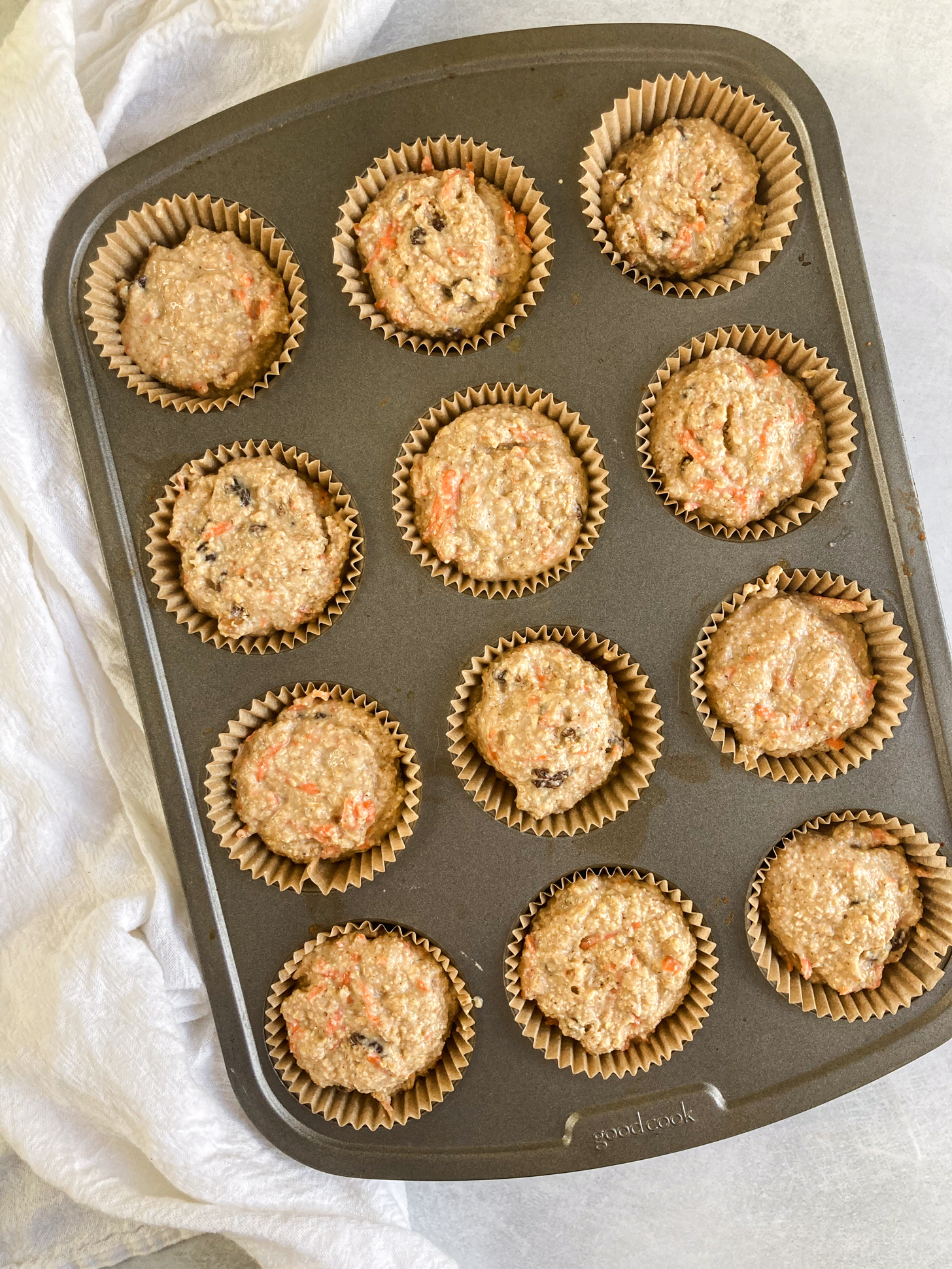 Muffin batter in a muffin pan. 