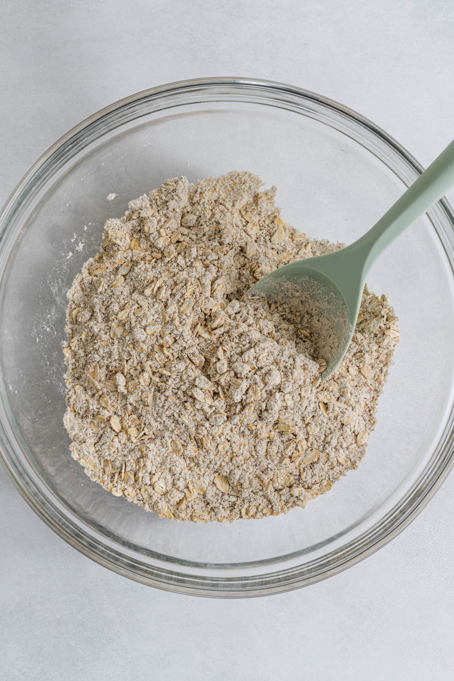 Dry ingredients mixed together in a large bowl with a spoon.