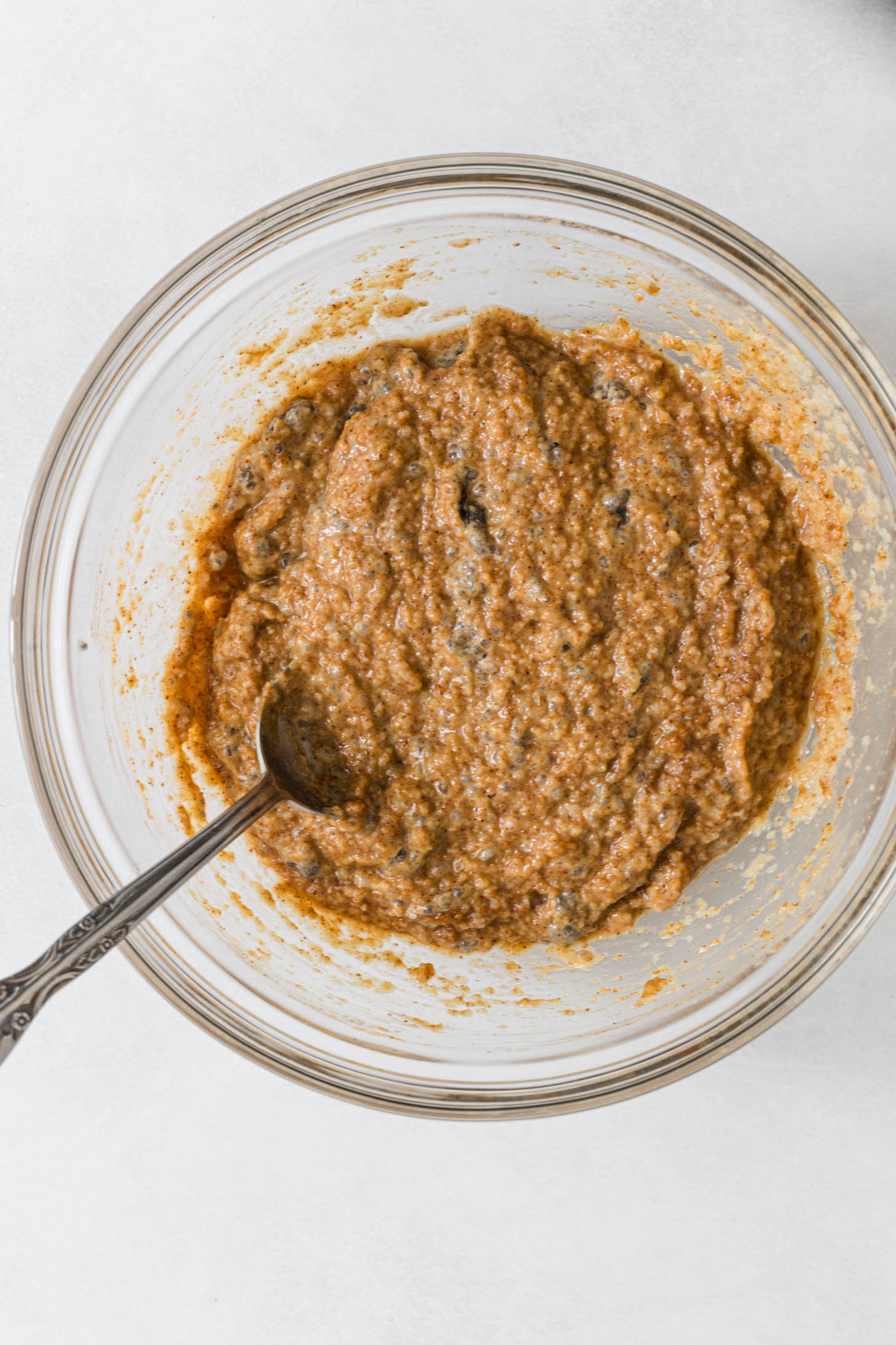 Wet ingredients mixed together in a bowl with a spoon.