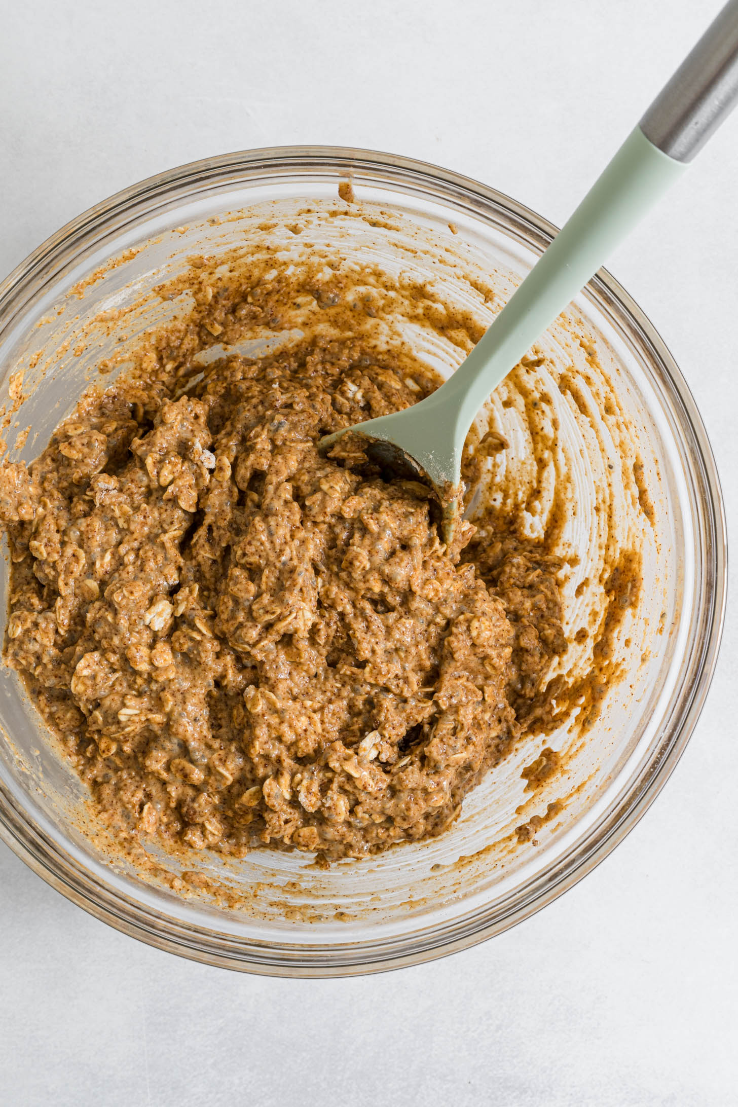 Dry and wet cookie ingredients mixed together in a bowl.