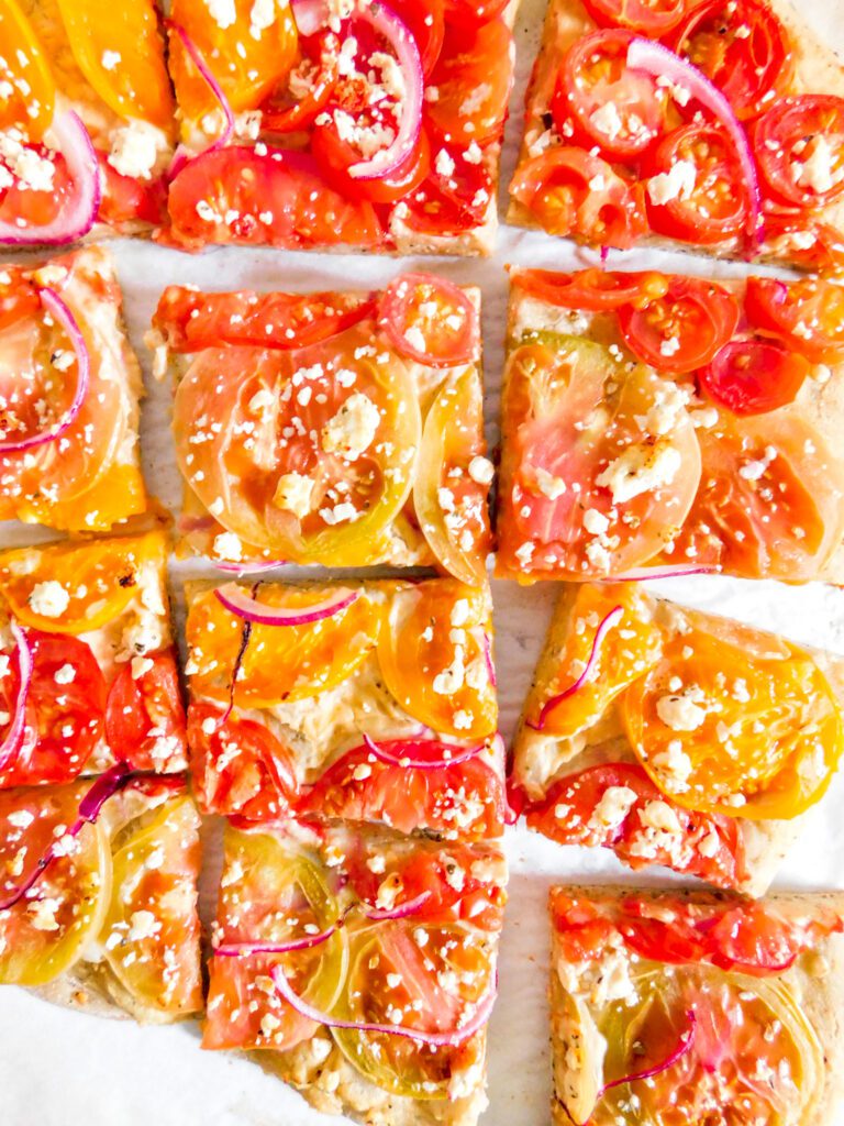 Hummus flatbread cut into slices.