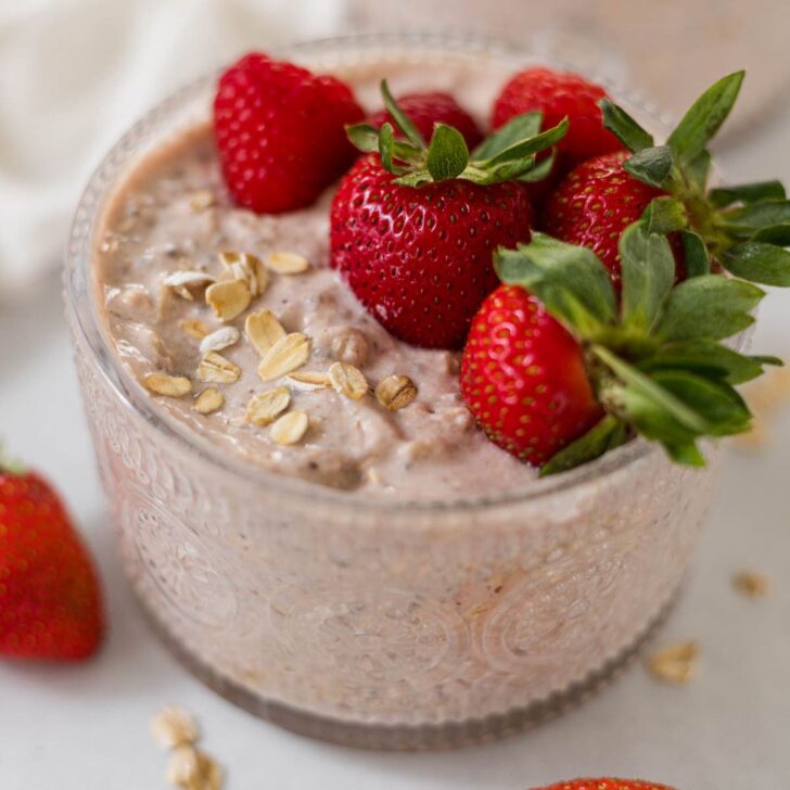 Berry cheesecake overnight oats with strawberries on top.