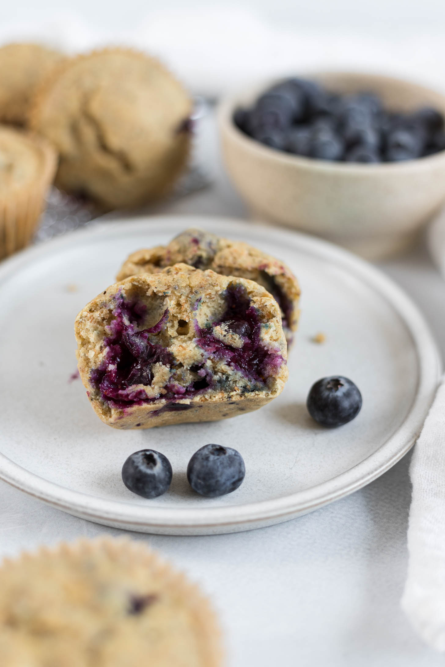 Half of a muffin on a plate.