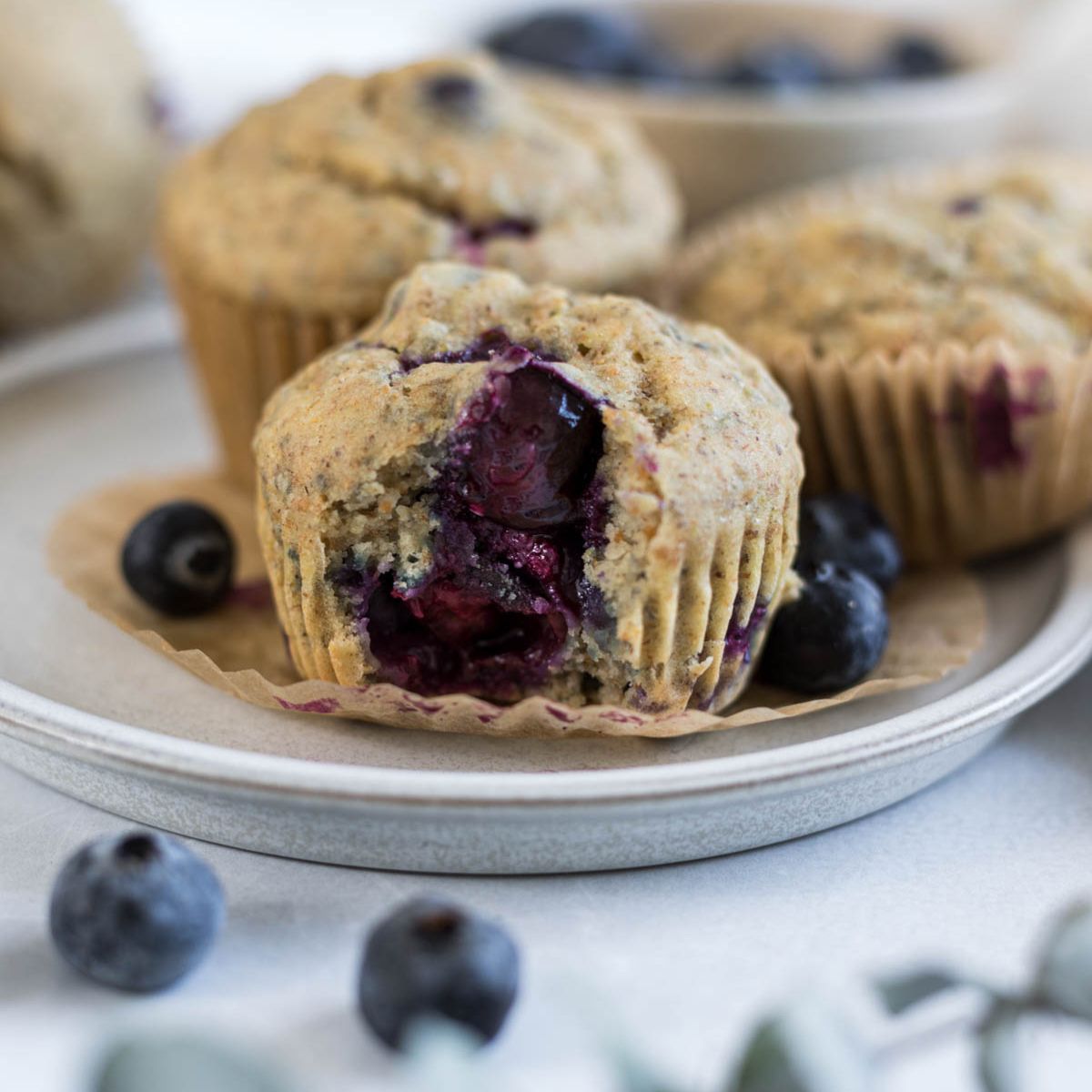 A blueberry muffin with a bite out of it.