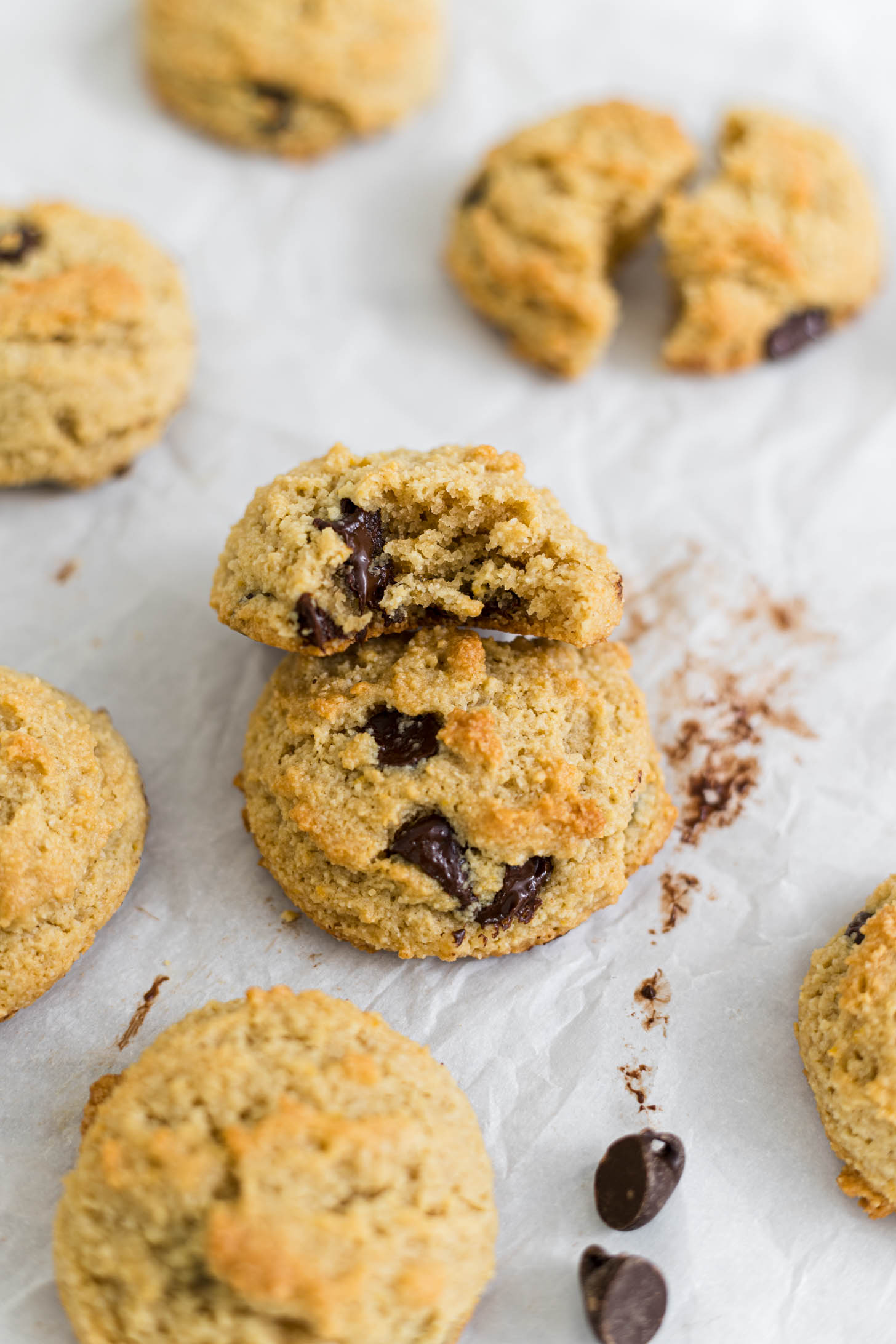 An almond flour chocolate chip cookie with a bite out of it resting on another cookie.