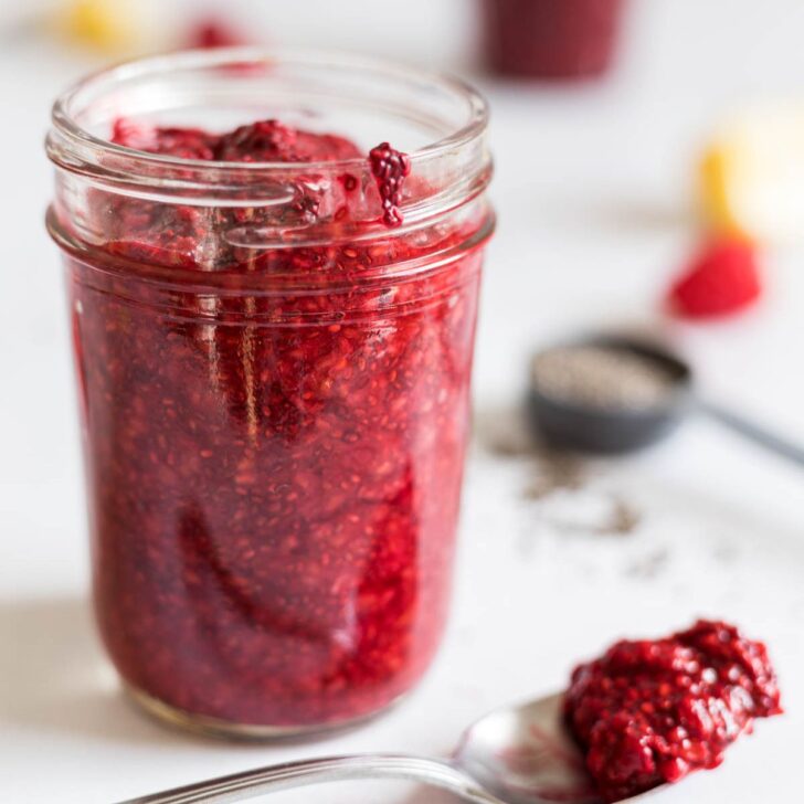 Raspberry jam in a mason jar.