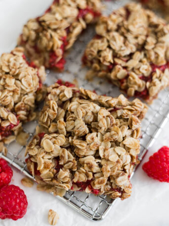 Raspberry Oatmeal Bars sit on a small wire rack.