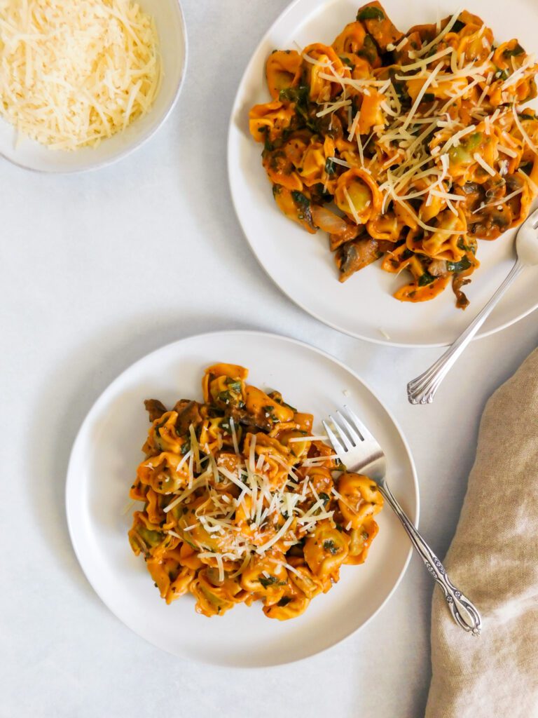 Two plates of tortellini.