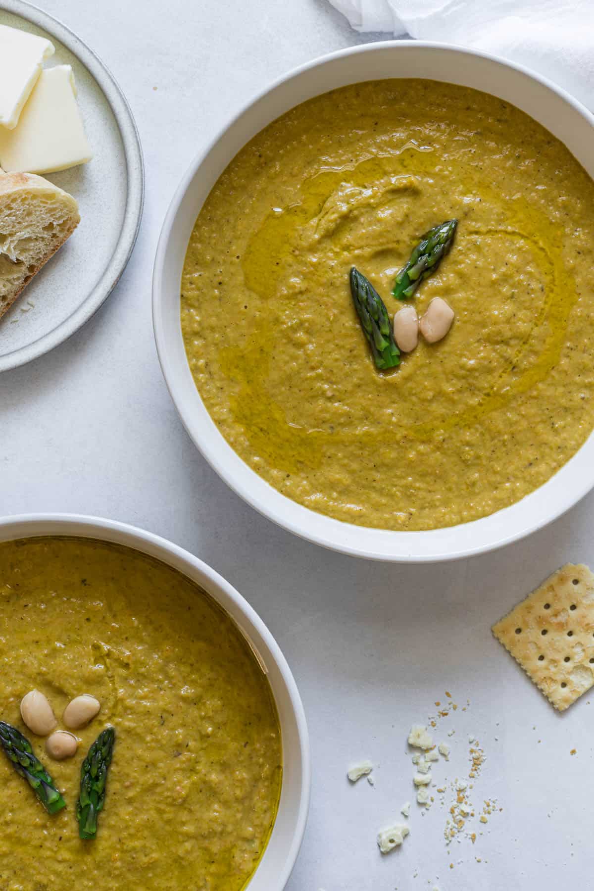 Two bowls of asparagus broccoli soup.