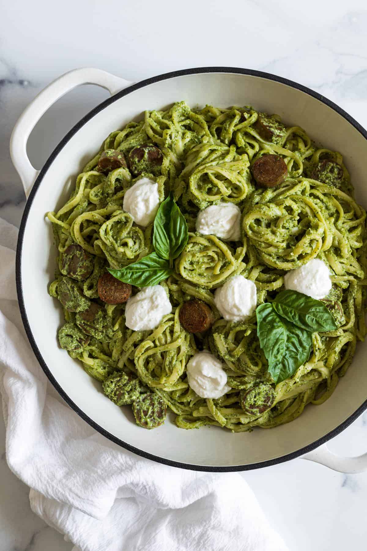 Overhead view of a pesto ricotta pasta in a big bowl.