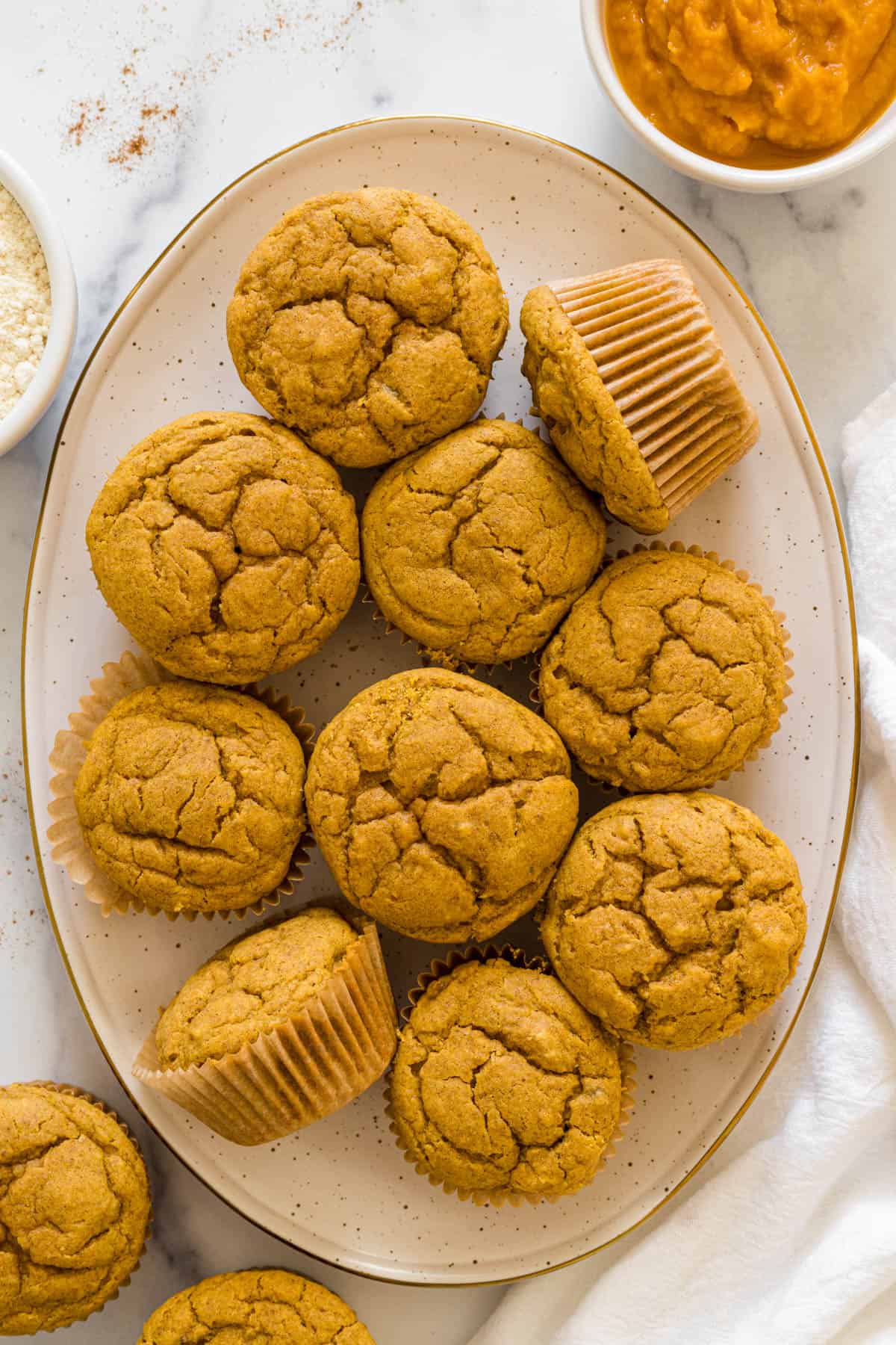 Pumpkin banana muffins on a plate.