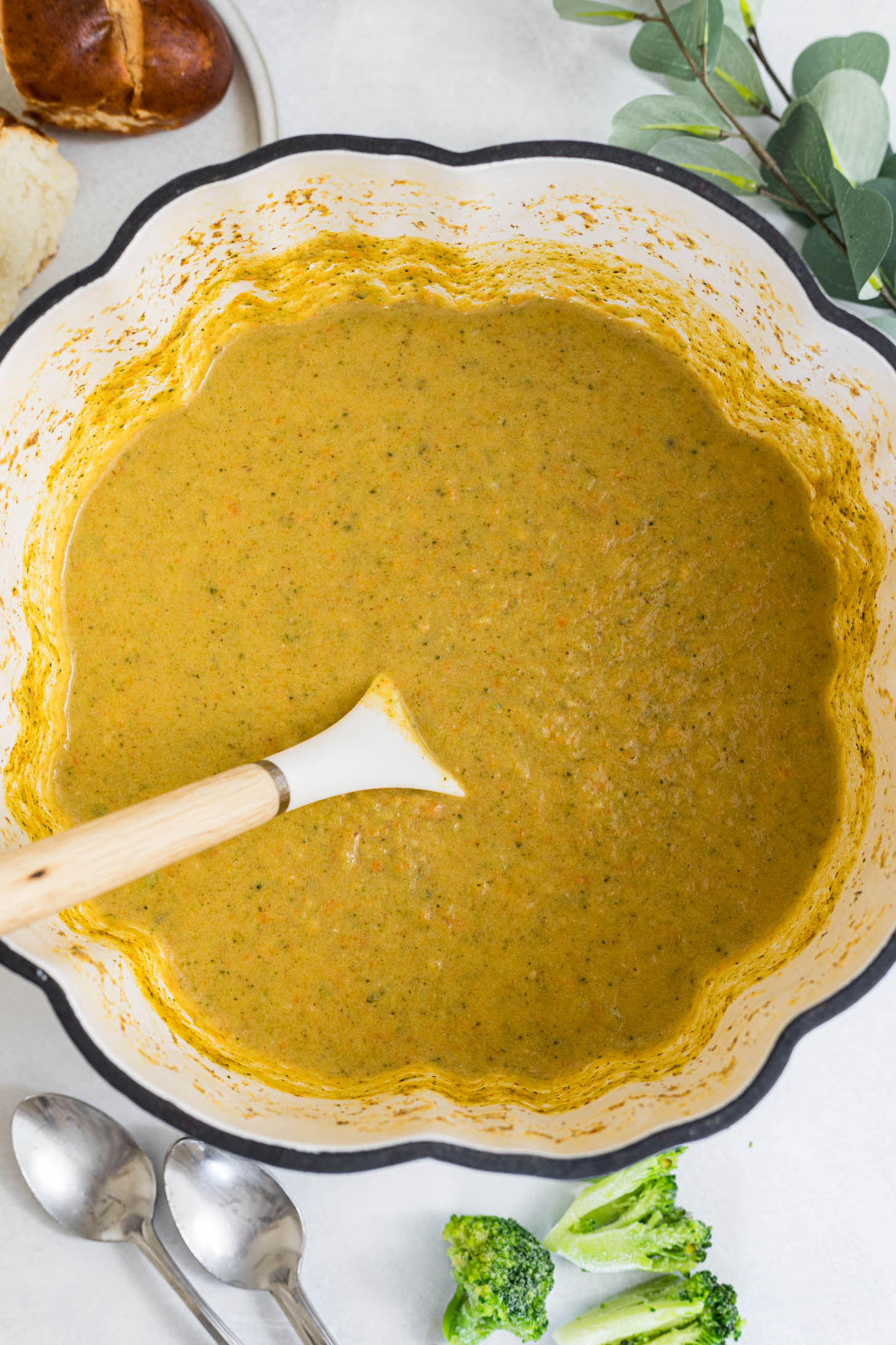 Broccoli cheddar soup in a dutch oven ready to be served.