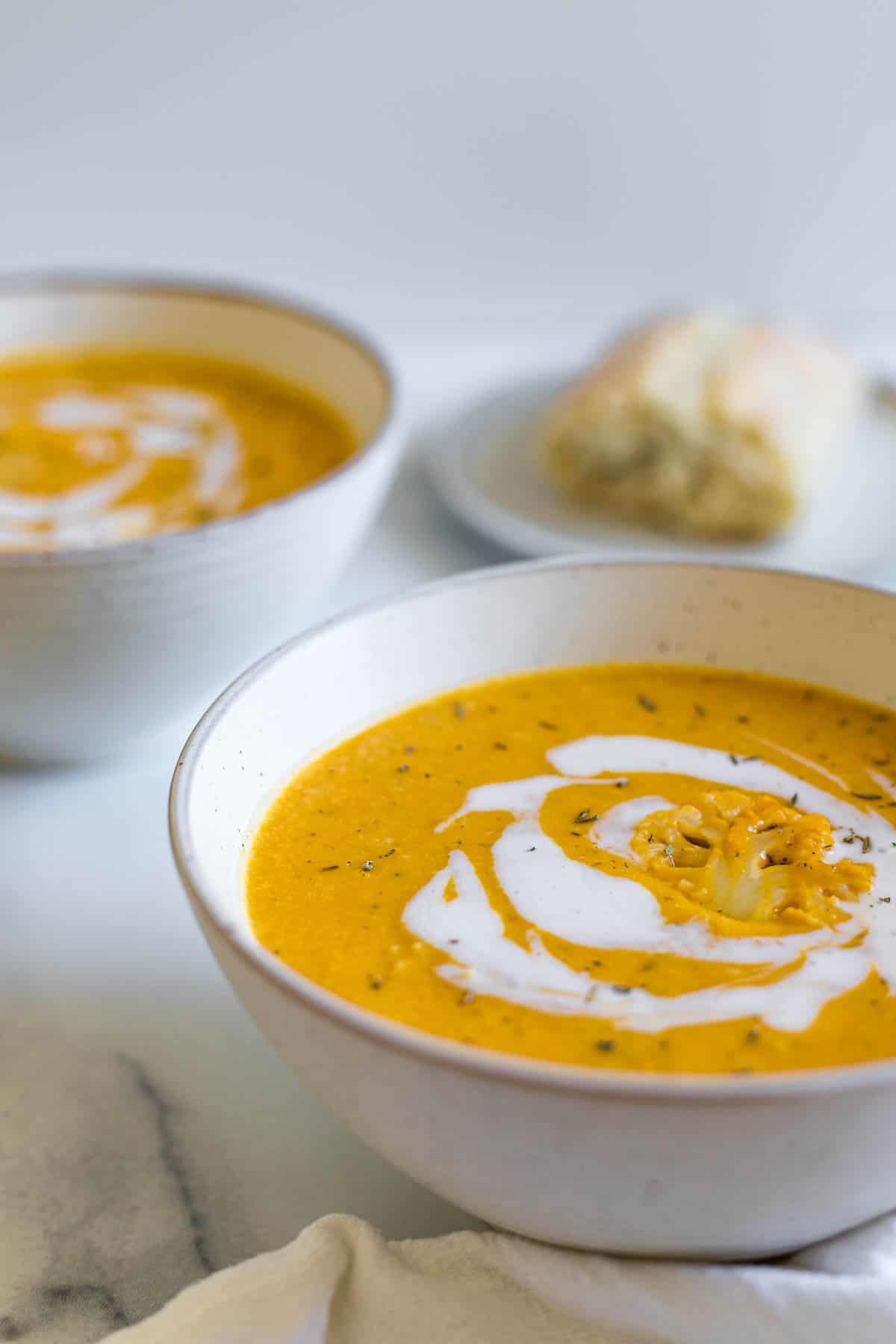 Two bowls of pumpkin soup.