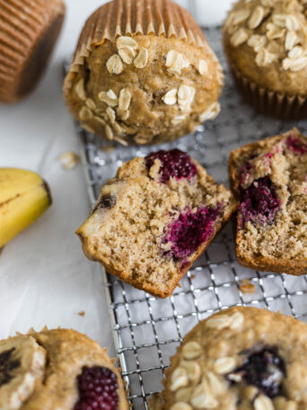 Close up of half of a blackberry muffin laying on it's side.