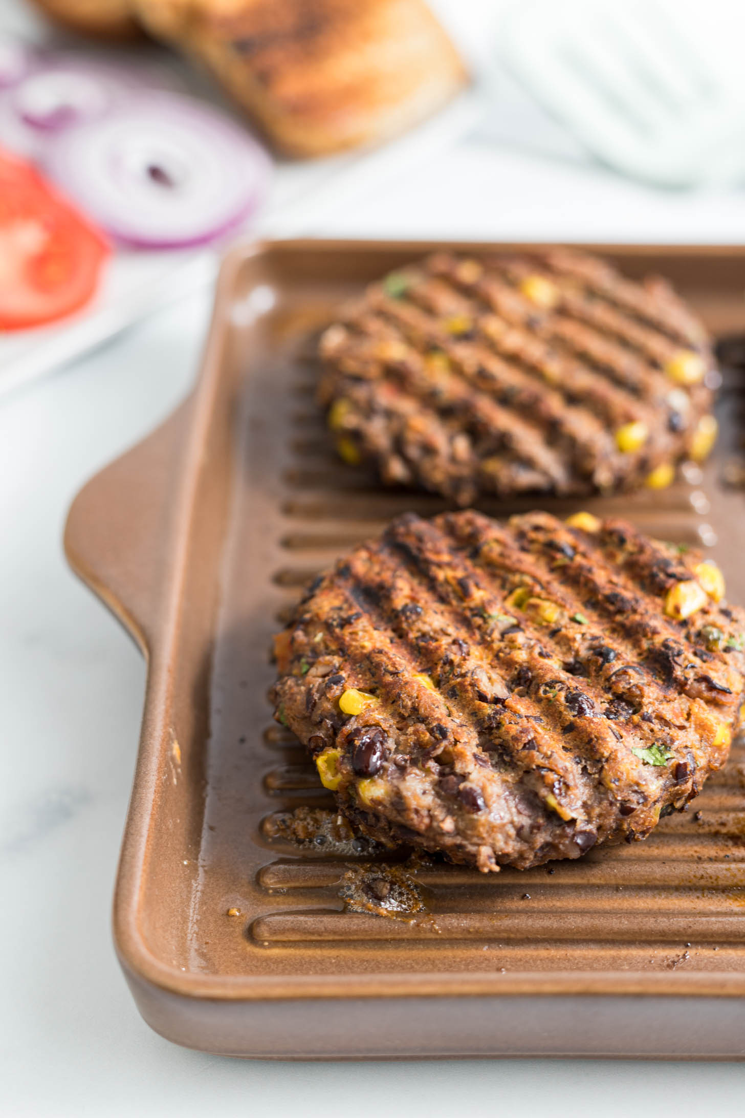 Cooked burgers on the grill pan.