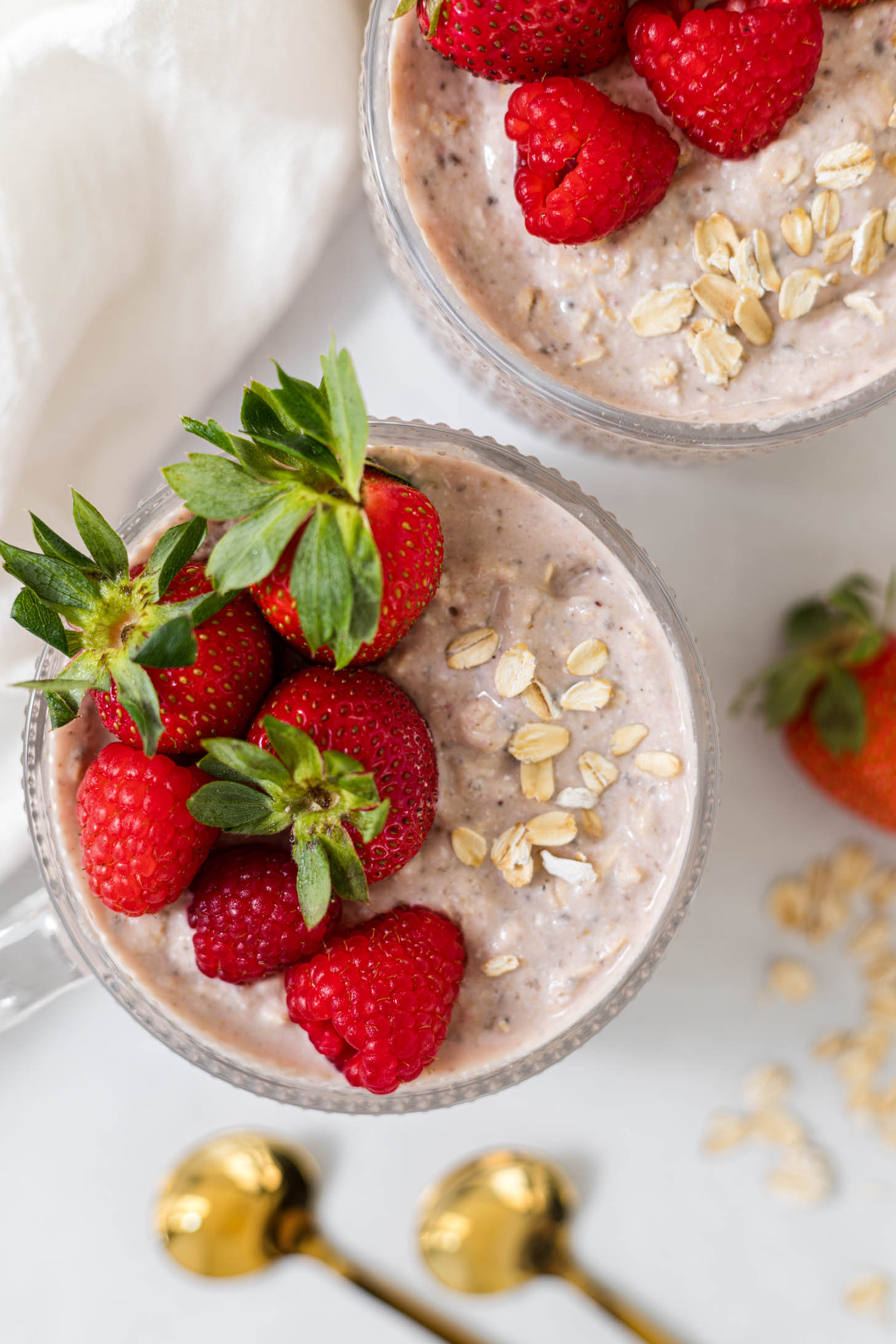 Overnight oats in a cup with berries on top.