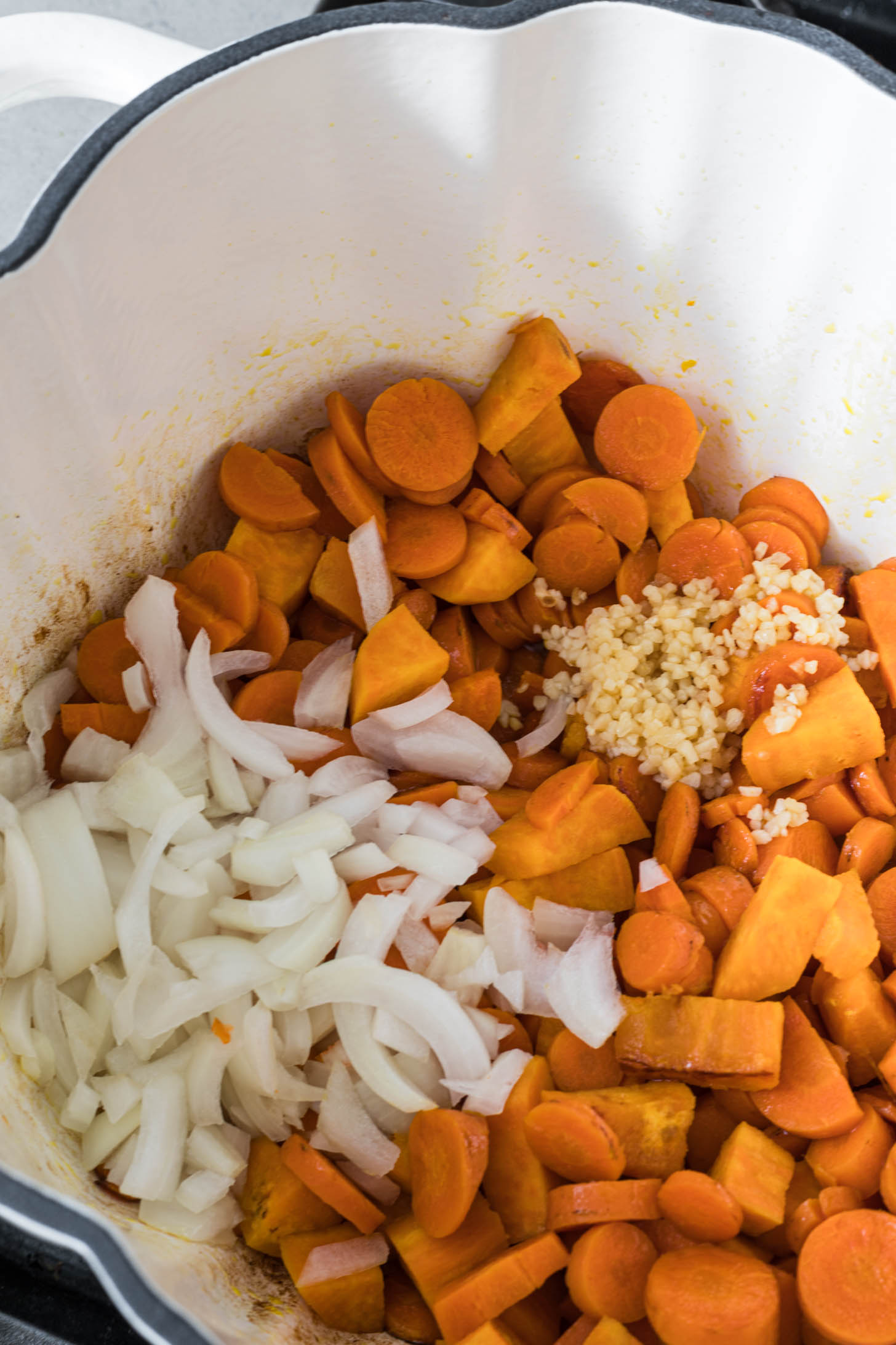 Garlic, onion, and ginger added to the pot.