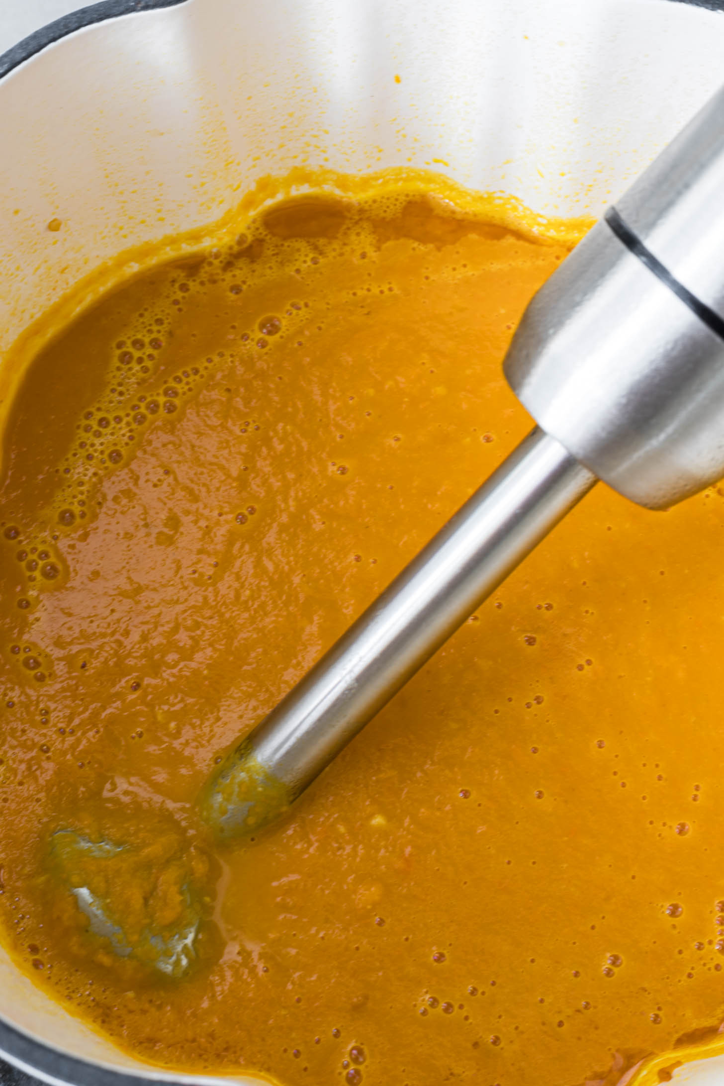 Carrot soup blended with an immersion blender.