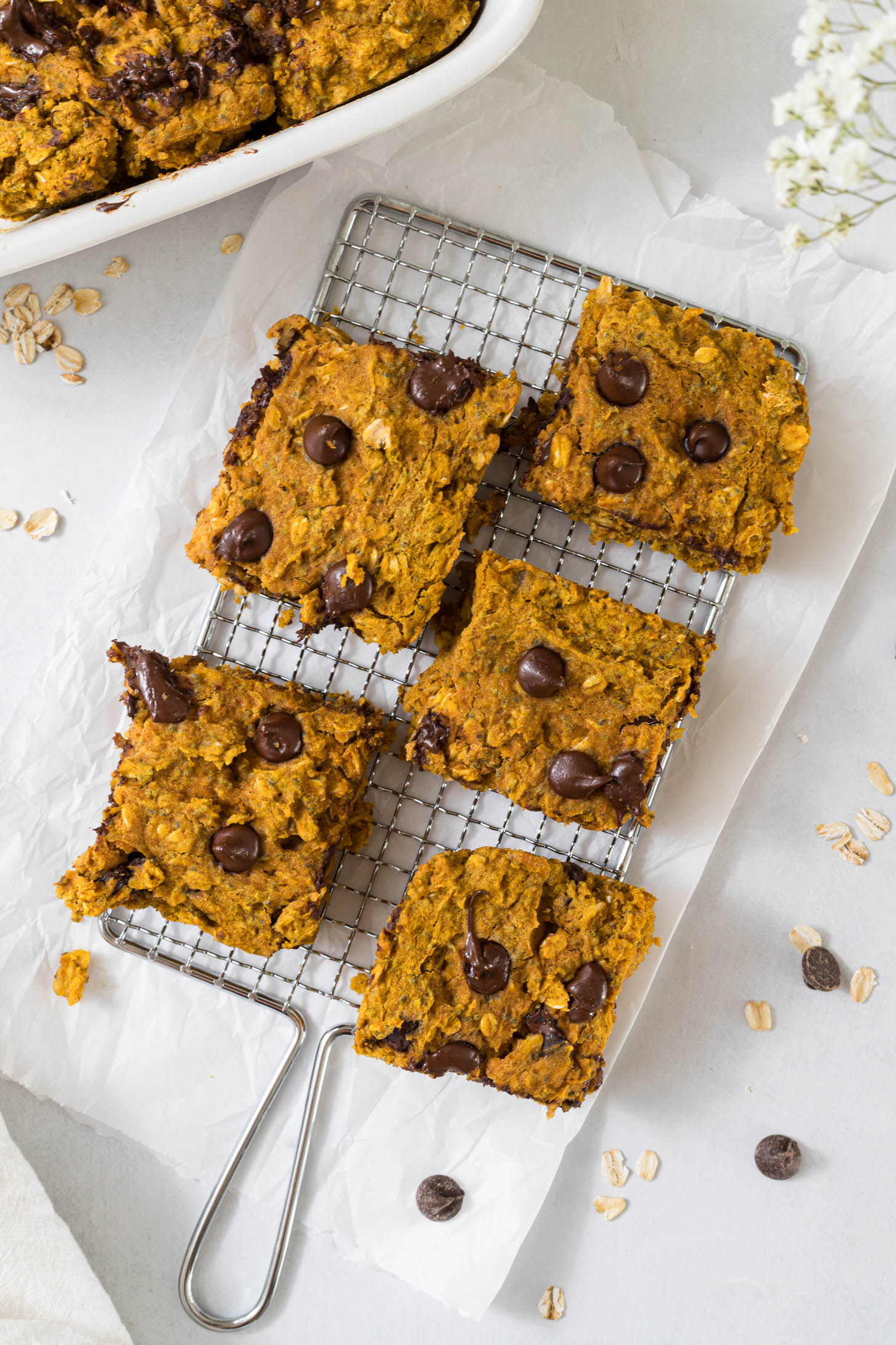 Overhead view of pumpkin bars on a wire rack.